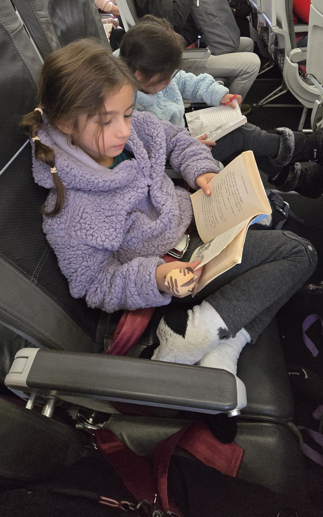 Julie was caught reading on the plane.jpg